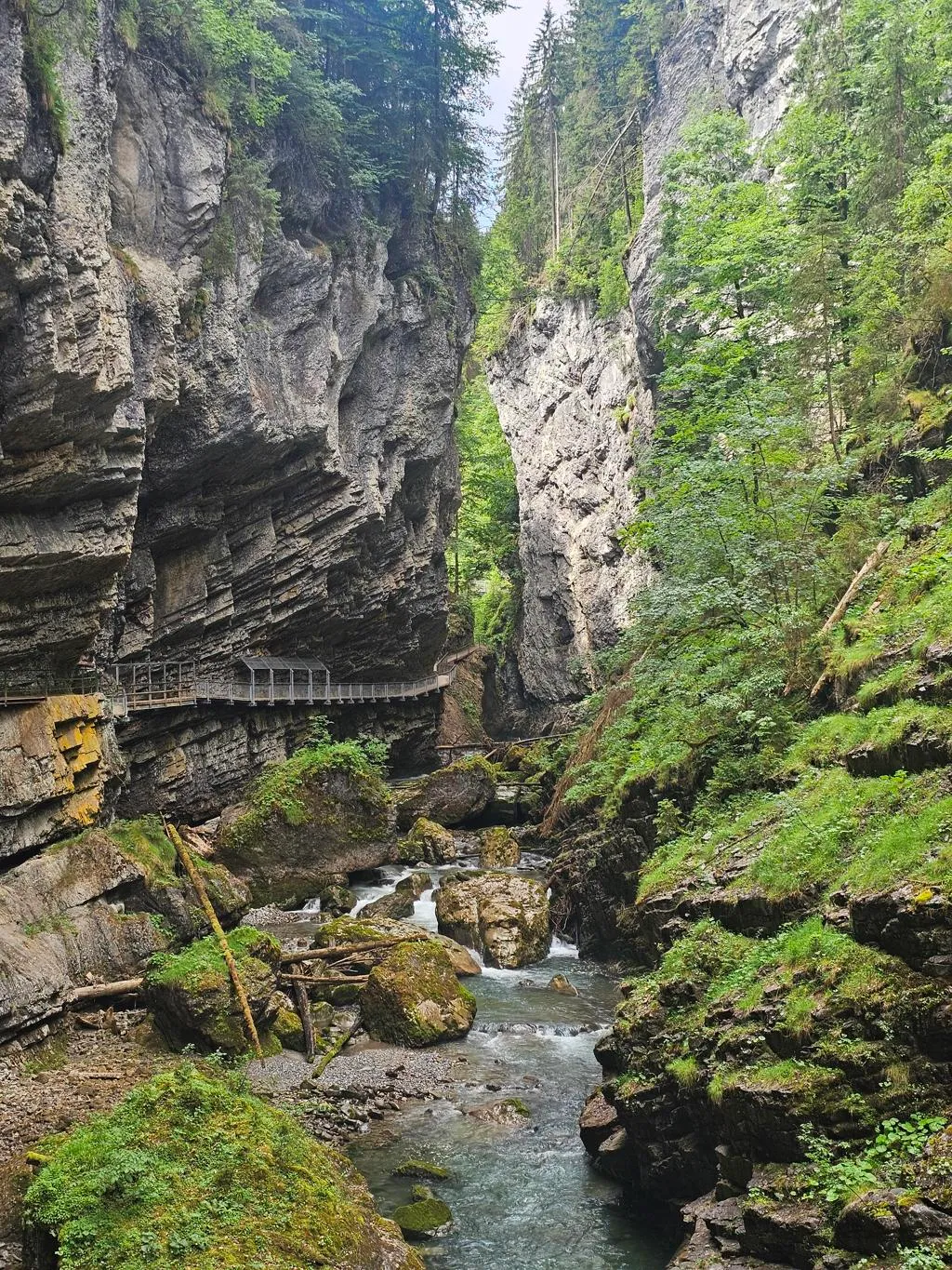 Pathway built into steep walls winding up a narrow gorge